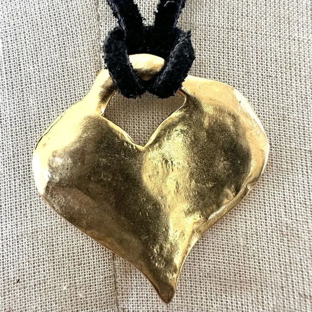 Gold tone heart pendant necklace on  black cord